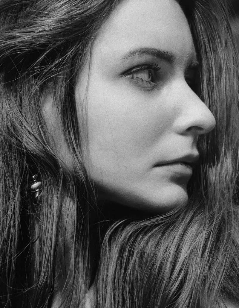 Black-and-white side profile of a woman with long hair